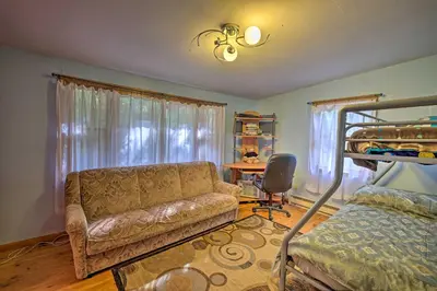 a living room with a couch and a bunk bed at Catskill Mtn Home with Deck about 1 Miles to Zoom Flume! in East Durham