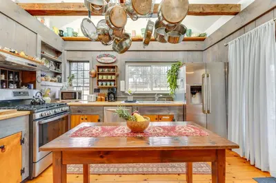 a kitchen with a wooden table with a bowl on it at Manchester Center Home with Green Mtn Views! in Manchester Center