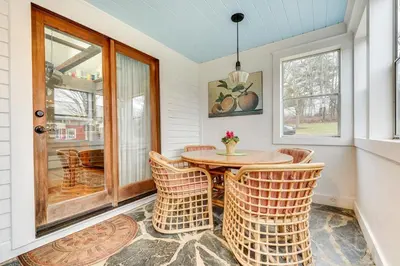 a dining room with a table and wicker chairs at Manchester Center Home with Green Mtn Views! in Manchester Center