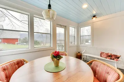 a dining room with a wooden table and chairs at Manchester Center Home with Green Mtn Views! in Manchester Center
