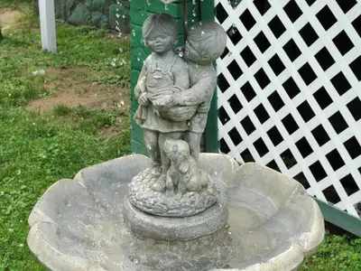 a statue of two children standing in a fountain at Anne's Washington Inn in Saratoga Springs