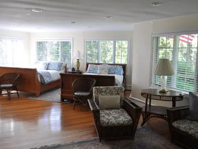 a living room with a bed and a couch at Anne's Washington Inn in Saratoga Springs