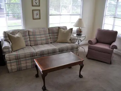 a living room with a couch and a chair and a coffee table at Anne's Washington Inn in Saratoga Springs