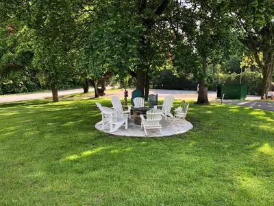 a group of chairs and a table in the grass at Anne's Washington Inn in Saratoga Springs