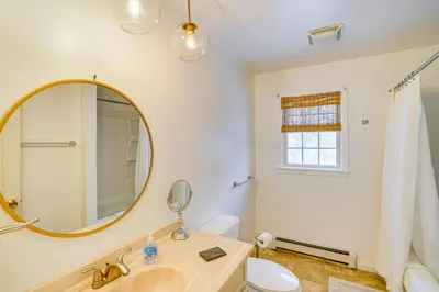 a bathroom with a sink and a mirror at Walk to Dining Downtown Lenox Guest House! in Lenox