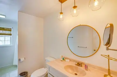a bathroom with a sink and a mirror at Walk to Dining Downtown Lenox Guest House! in Lenox