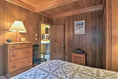 a bedroom with a bed and a dresser and a lamp at Lakefront Berkshires Retreat with Deck, Dock and Boat! in Great Barrington