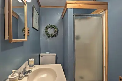 a bathroom with a toilet and a sink and a shower at Lakefront Berkshires Retreat with Deck, Dock and Boat! in Great Barrington