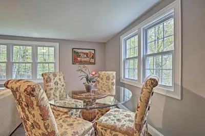 a dining room with a glass table and chairs at Beautiful Lenox Home, 3 Mi to Shakespeare and Co! in Lenox