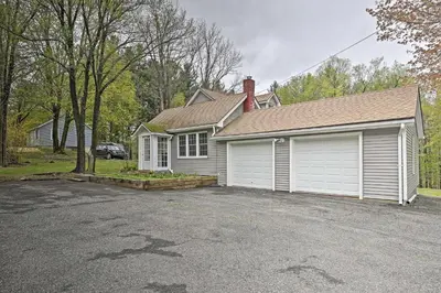 a house with a car parked in front of a driveway at Beautiful Lenox Home, 3 Mi to Shakespeare and Co! in Lenox
