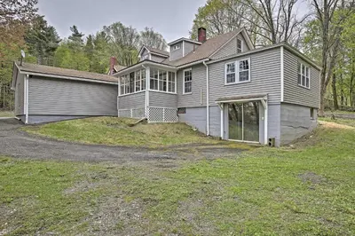 a large house with a garage in the yard at Beautiful Lenox Home, 3 Mi to Shakespeare and Co! in Lenox