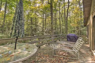 a patio with a table and chairs on a porch at Cabin with 3 Acres, Tennis Courts By 4 Ski Mtns in Sandisfield