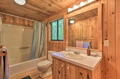a bathroom with a sink and a toilet and a shower at Cabin with 3 Acres, Tennis Courts By 4 Ski Mtns in Sandisfield