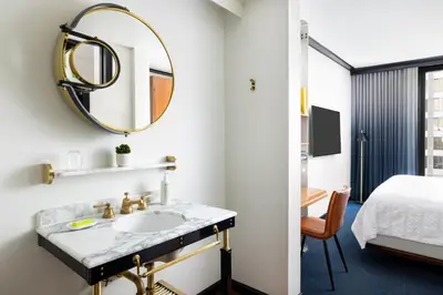 a bathroom with a sink and a mirror at Le Meridien New York, Central Park in New York