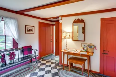 a room with red doors and a desk and a window at Tranquil 3 BR Stockbridge House with Private Deck! in Stockbridge