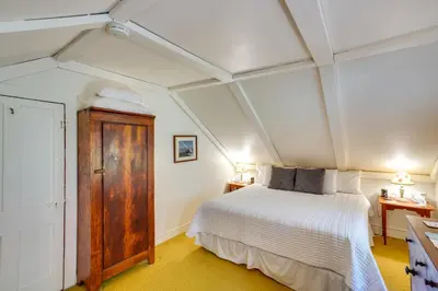 a bedroom with a bed and two night stands at Tranquil 3 BR Stockbridge House with Private Deck! in Stockbridge