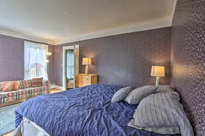 a bedroom with a blue bed with two pillows at Catskills House 1 Mi to Windham Mountain Resort! in Windham