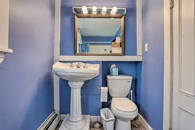 a blue bathroom with a sink and a toilet at Catskills House 1 Mi to Windham Mountain Resort! in Windham