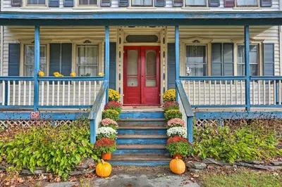 a house with a red door and pumpkins on the porch at Catskills House 1 Mi to Windham Mountain Resort! in Windham