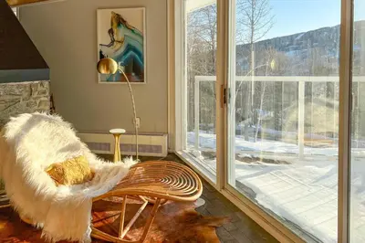 a room with a bench and a large window at Pristine West Dover Home with Deck and Mountain Views! in West Dover