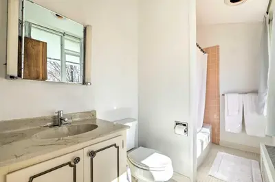 a bathroom with a sink and a toilet and a mirror at Pristine West Dover Home with Deck and Mountain Views! in West Dover