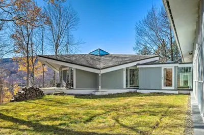 a small white house with a grass yard at Pristine West Dover Home with Deck and Mountain Views! in West Dover