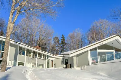 a house with snow in front of it at Pristine West Dover Home with Deck and Mountain Views! in West Dover
