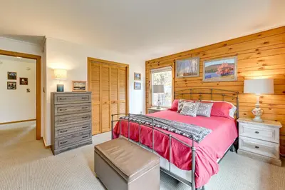 a bedroom with a bed and a dresser and a drawer at High Peak Heaven Cozy Log Cabin on 1 Acre! in Windham