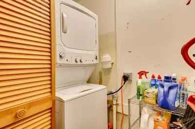 a washer and dryer sitting on top of a refrigerator at High Peak Heaven Cozy Log Cabin on 1 Acre! in Windham