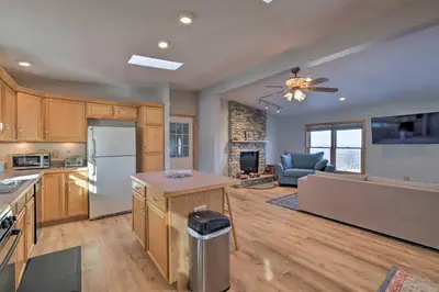 a kitchen with a refrigerator and a living room at Catskills Mtn Retreat with Panoramic View and Fire Pit in Cornwallville