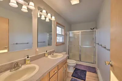 a bathroom with two sinks and a glass shower at Catskills Mtn Retreat with Panoramic View and Fire Pit in Cornwallville