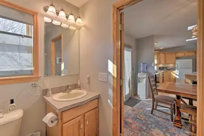a bathroom with a sink and a toilet and a table at Catskills Mtn Retreat with Panoramic View and Fire Pit in Cornwallville