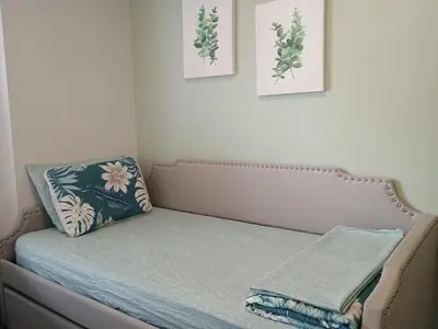 a bed in a room with two pictures on the wall at Explore New York from Queens in Queens