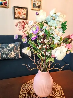 a pink vase filled with flowers on a table at Explore New York from Queens in Queens