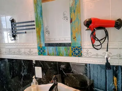 a blow dryer on a wall next to a sink at Explore New York from Queens in Queens