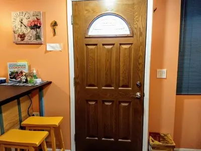 a wooden door in a room with a window at Cozy studio at the heart of Jackson Heights in Queens