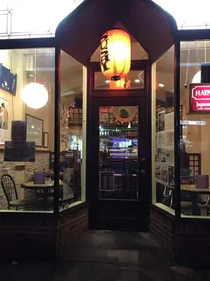 a restaurant with a chinese light hanging over the door at Cozy studio at the heart of Jackson Heights in Queens