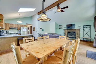 a kitchen and dining room with a wooden table and chairs at Secluded Family Cabin with Fire Pit in Lake Ariel! in Lake Ariel