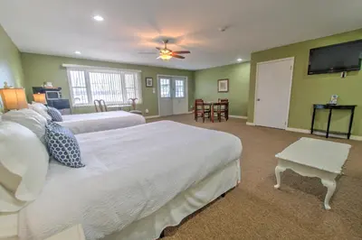 a bedroom with two beds and a flat screen tv at East Shore Lodging in Hawley
