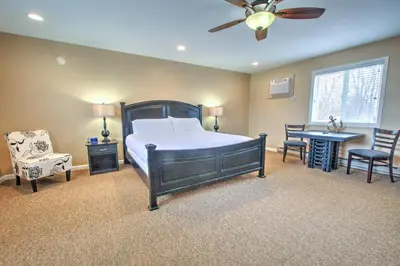 a bedroom with a bed and a table and chairs at East Shore Lodging in Hawley