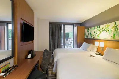 a hotel room with two beds and a desk at Hilton Garden Inn New York Central Park South-Midtown West in New York