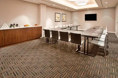 a conference room with a long table and chairs at Hilton Garden Inn New York Central Park South-Midtown West in New York