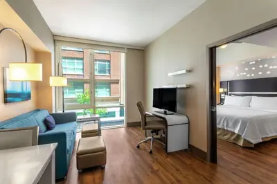 a hotel room with a bed and a desk with a tv at Homewood Suites Midtown Manhattan Times Square South in New York