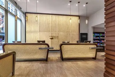 a waiting room with wicker chairs in a store at Homewood Suites Midtown Manhattan Times Square South in New York