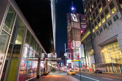 a busy city street at night with buildings and cars at Hilton Garden Inn New York - Times Square Central in New York