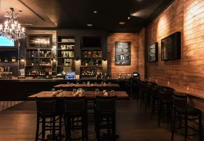 a restaurant with tables and chairs and a bar at Hilton Garden Inn New York/Midtown Park Avenue in New York