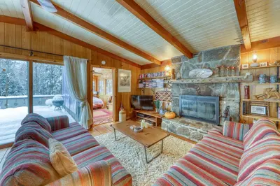 a living room with a couch and a fireplace at Mount Snow Chalet in West Dover
