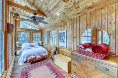 a bedroom with a bed and a mirror in a cabin at Mount Snow Chalet in West Dover