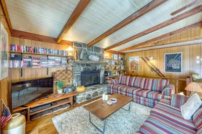 a living room with a couch and a fireplace at Mount Snow Chalet in West Dover