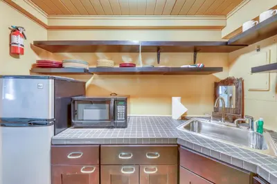a kitchen with a sink and a microwave at Mount Snow Chalet in West Dover